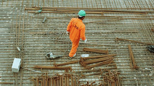 A concreter is laying rebar