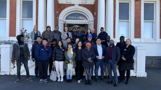 Group of 30 people standing outside Ararat Town Hall and smiling for camera