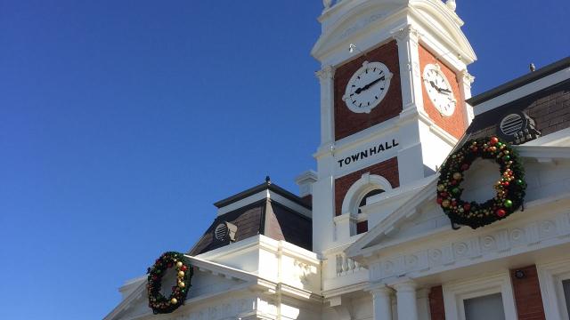 Town Hall building with Christmas wreaths on its towers
