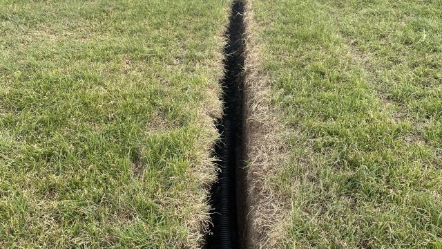 Large green oval area with deep channel running through