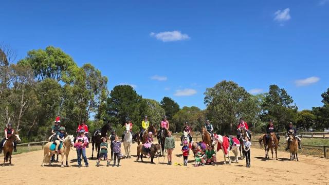 A group of people riding horses