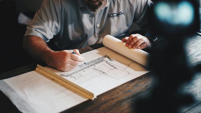 A draftsperson is working on building plans