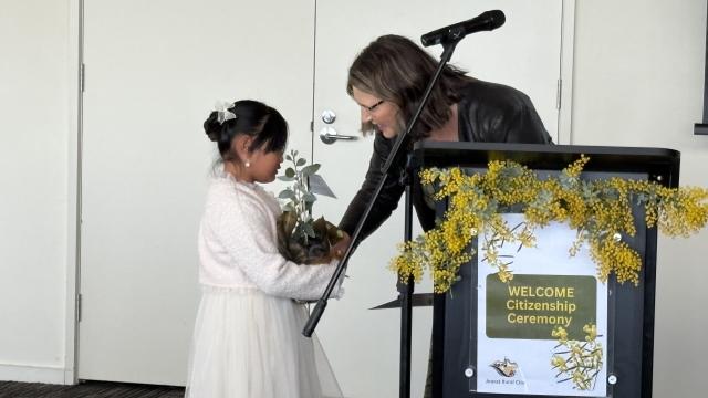 Mayor Cr Jo Armstrong presents a new Australian citizen.