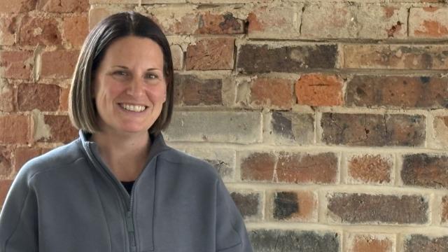 Lisa from Laneway Pilates is smiling in front of the new studio