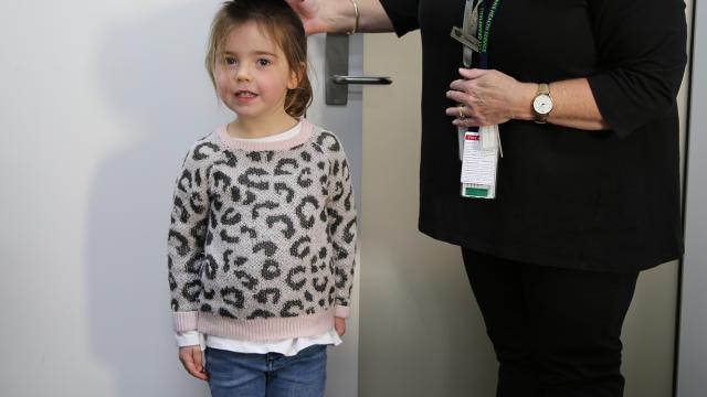 A child health nurse is assisting a child