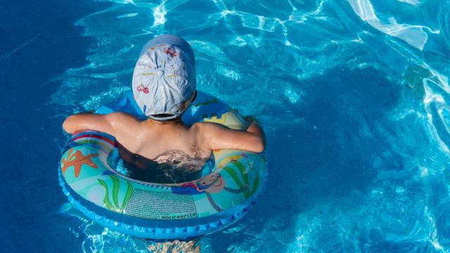 young boy learning to swim