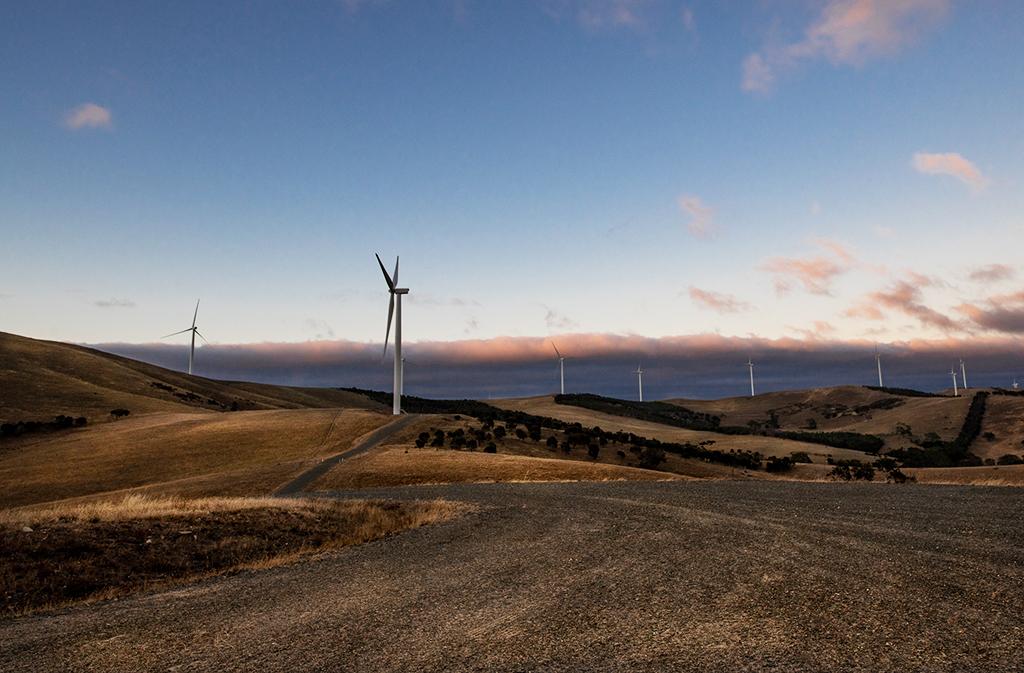 Wind turbine on the top of a hill in a rural landscape