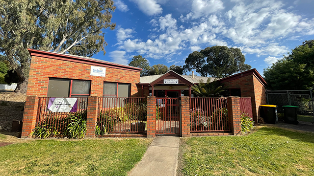 Long shot of the outside of a kindergarten on a sunny day
