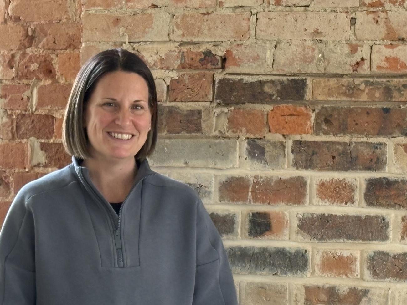 Lisa from Laneway Pilates is smiling in front of the new studio